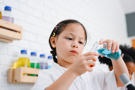 Child in classroom at school, Kid dressed Science lab coat. Science conceptの写真素材