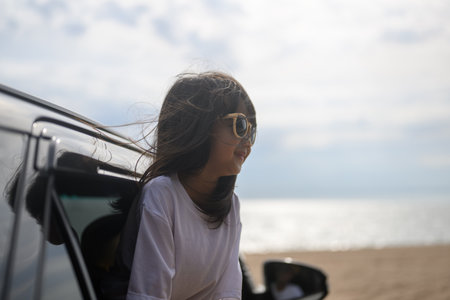 Happy Asian family travel on beach on holidayの写真素材