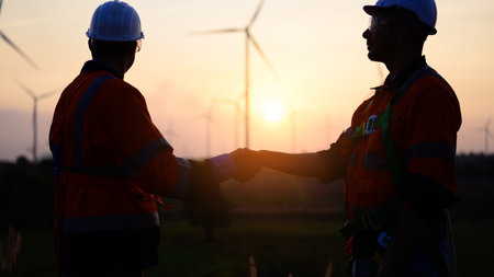 Professional engineer technician working outdoor at wind turbine fieldの写真素材