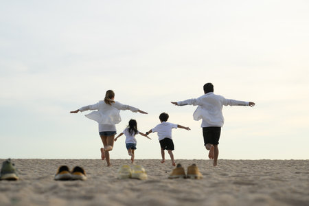 Happy Asian family travel on beach on holidayの写真素材