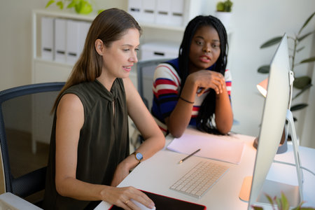 Happy female dressmaker working in workshop studioの写真素材