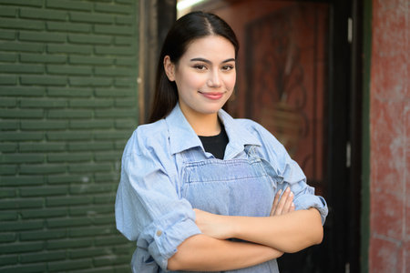 Confident female business owner taking photo front of her storeの写真素材