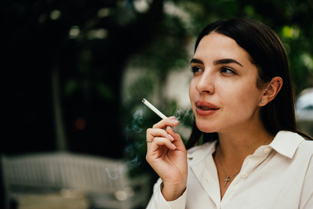 Young couple of man and woman smoking cigarette togetherの写真素材