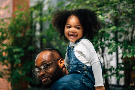 Portrait of happy family father mother and daughter at homeの写真素材
