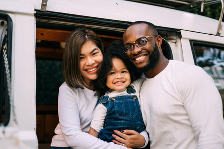 Portrait of happy family father mother and daughter at home