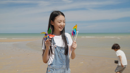 Happy Asian family with barbecue party at camping beach togetherの写真素材