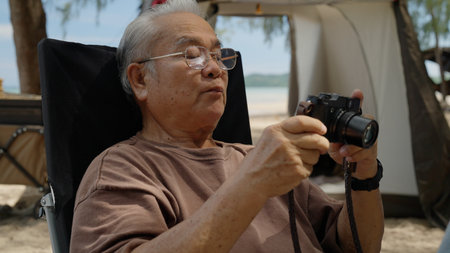 Happy Asian family with barbecue party at camping beach togetherの写真素材