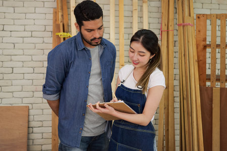 Carpenters making furniture in wood workshopの写真素材