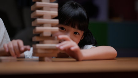 Excited girl playing game with positive senior grandparentsの写真素材