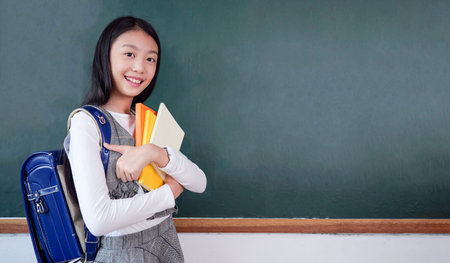 Student studying and reading textbook with happiness in classroomの写真素材