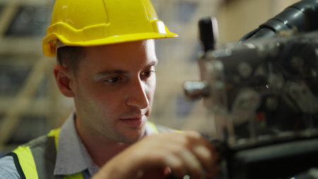 Maintenance engineer with robotic arms at industrial factoryの写真素材