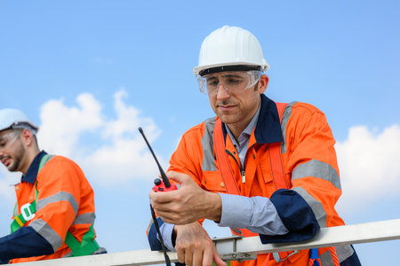Professional engineer technician team working at wind turbine farm field