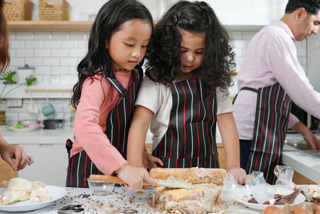 Child making cake with family, Family having fun together in kitchenの写真素材