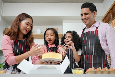 Child making cake with family, Family having fun together in kitchenの写真素材