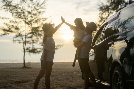 Happy Asian family travel on beach on holidayの写真素材