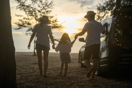 Happy Asian family travel on beach on holidayの写真素材