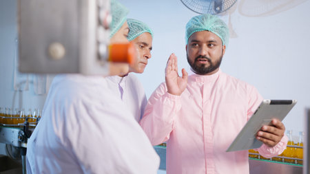 Factory worker technician checking and controlling at food and beverage factory