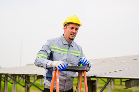 Professional engineer checking and maintaining solar panels on solar cell farm