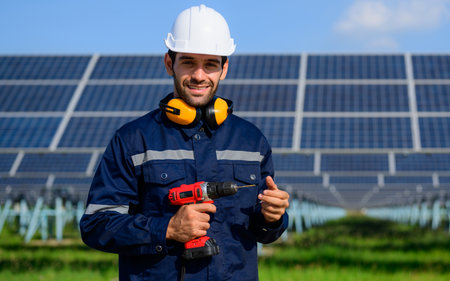 Technician worker installing solar panels at solar cell farmの写真素材