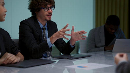 Businessmen and businesswomen meeting together in conference room