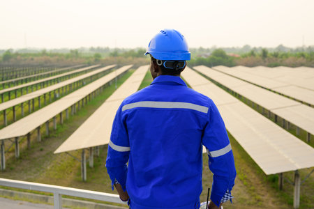 Engineer worker checking and maintaining solar panels on solar farm