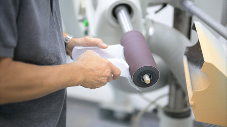 Technician sculpting plaster cast for socket at prosthetic factoryの写真素材