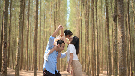Happy family having fun with activities together in park on weekendの写真素材