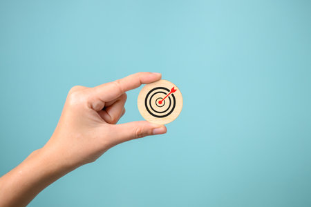Hand putting business icons on wooden cubic blocksの写真素材
