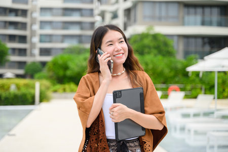 Smiling portrait of businesswoman working outdoor officeの写真素材