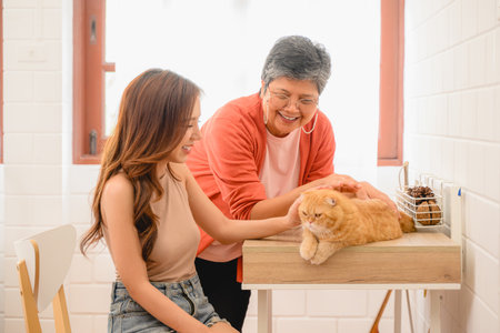A senior with her daughter is depicted in a happy portrait at their homeの写真素材