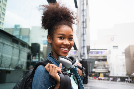 Smiling happy woman walking on street with backpack in city