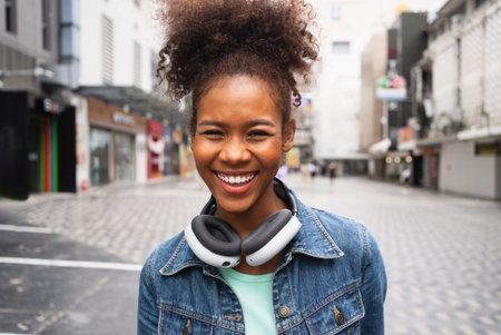 Smiling happy woman walking on street with backpack in cityの写真素材