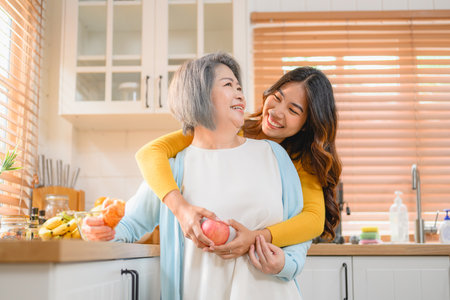 happy family grandmother with daughter portrait. cheerful family in kitchen smiling together.の写真素材
