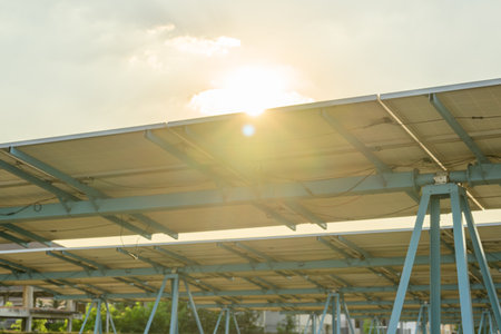 Photovoltaic solar panels with sunset at solar cell farm field