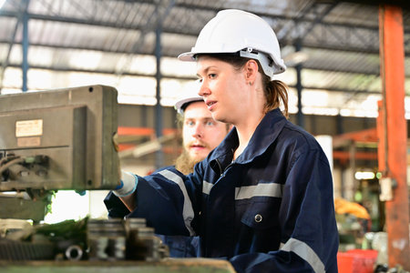 Mechanical engineers repairing engine machine at factoryの写真素材