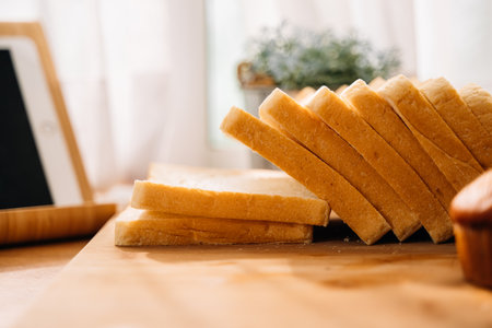 Fresh homemade baked bread and sliced bread on wooden table