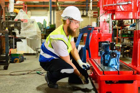 Mechanical engineer repairing engine machine at factory