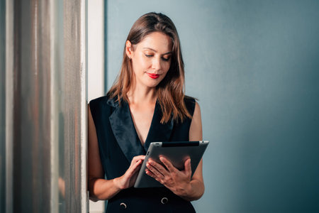 Beautiful businesswoman using tablet working at companyの写真素材