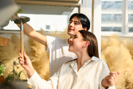 Couple of happy young people spending time together at home on weekendの写真素材