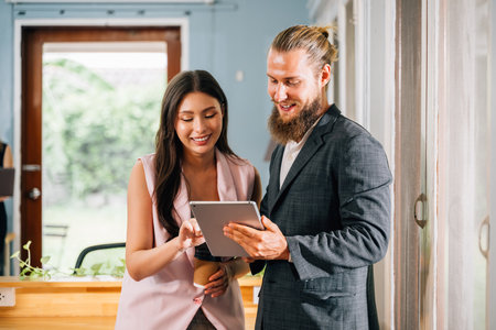 Happy couple of business people meeting and brainstorming togetherの写真素材