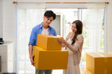 Man and woman accepting and holding delivery parcel boxes from deliveryman at home, Delivery service...