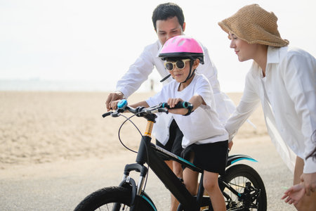 Happy family spending good time with outdoor activities on beachの写真素材
