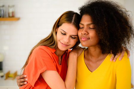Happy young lesbian couple embracing together, Couple of friends relaxing and spending time on weekend at home, Couple of female lovers with good relationship, Concept of LGBTQの写真素材