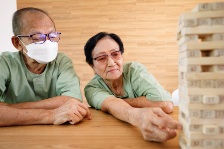 Group of senior people sitting on sofa having activities together at nursing home, Doctor and nurse assisting elderly people at retirement home, Health care at hospital or nursing homeの写真素材
