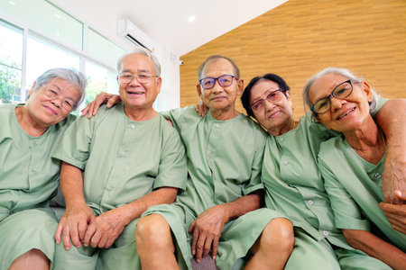 Group of senior people sitting on sofa having activities together at nursing home, Doctor and nurse assisting elderly people at retirement home, Health care at hospital or nursing homeの写真素材