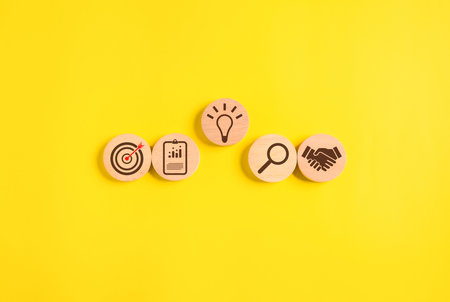 Wooden block of target board with business iconsの写真素材