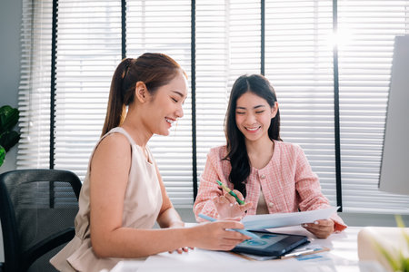 Couple of business people working together at modern officeの写真素材