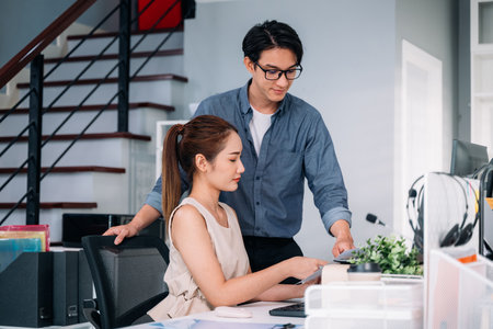 Couple of business people working together at modern officeの写真素材