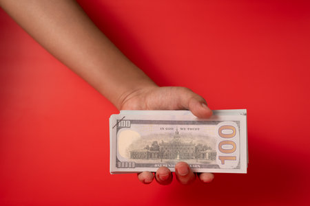 People holding many hundred dollar bills and banknotes for money saving, American dollars, Cash money dollars, Business investment and income, Global financial crisis, Earning and saving money conceptの写真素材