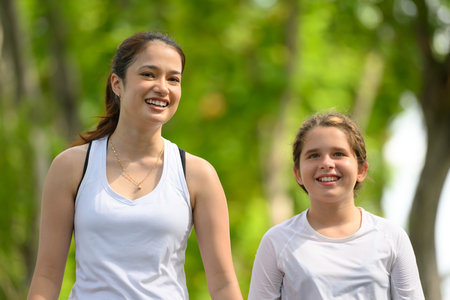 Couple of healthy young woman and girl enjoying and relaxing yogaの写真素材